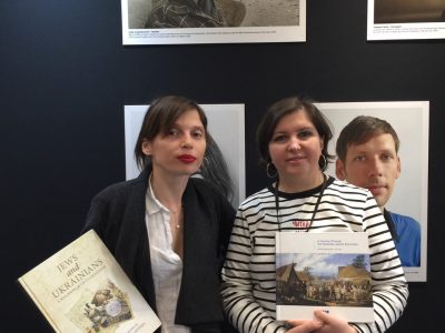 Popular Ukrainian writer and singer Irena Karpa (left) and Ukrainian translator and educator Iryna Dmytryshyn (left) hold two books sponsored by the Ukrainian Jewish Encounter at the Salon du Livre de Paris/Paris Book Fair. The books are “Jews and Ukrainians: A Millennium of Co-Existence” by UJE board member Paul Robert Magocsi and Yohanan Petrovsky-Shtern and “A Journey Through the Ukrainian Jewish Encounter: From Antiquity to 1914” by UJE co-director Alti Rodal. Sofia Andrukhovych, one of the authors of the UJE-sponsored publication “The Key in the Pocket” is in the background.