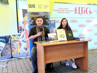 Владислав Гриневич, керівник офісу UJE в Україні, презентує відвідувачам Х ювілейного книжкового фестивалю «VinBookFest» книжки, видані за підтримки UJE, та розповідає про діяльність та місію організації. 10 вересня 2023 року, місто Вінниця. 