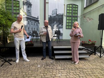 Мирослав Ліщинський (ліворуч) та Лілія Савків (праворуч) з громадської організації «Бучач-Арт» представляють Василя Махна (посередині).